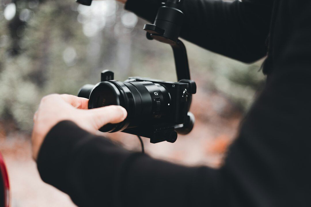 Camera operator filming with a professional broadcast camera
